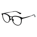 A pair of oval eyeglasses with a black frame and transparent lenses, featuring a metallic browline.
