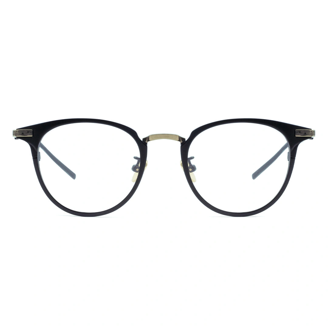 A pair of oval eyeglasses with a sleek frame design, featuring a blend of black and gold metal.