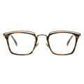 A pair of rectangular eyeglasses with a browline design, featuring a tortoise frame and transparent lenses.