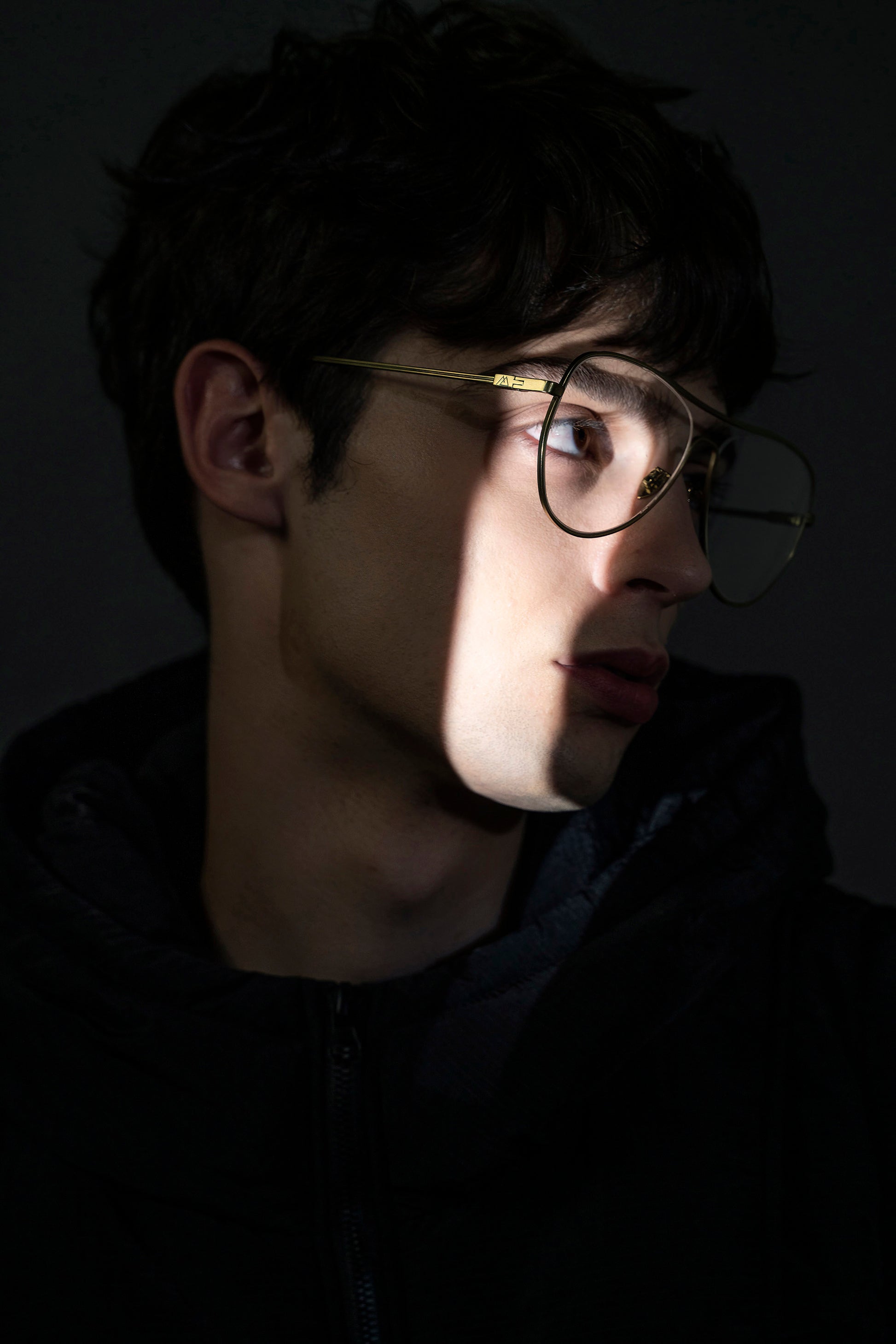 A model wears AIKTON eyeglasses