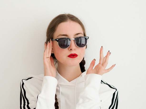 oval face female in black semi rim sunglasses