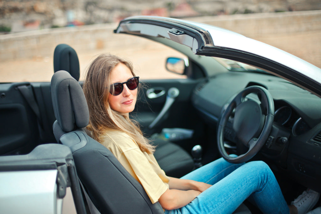 a woman wearing driving sunglasses