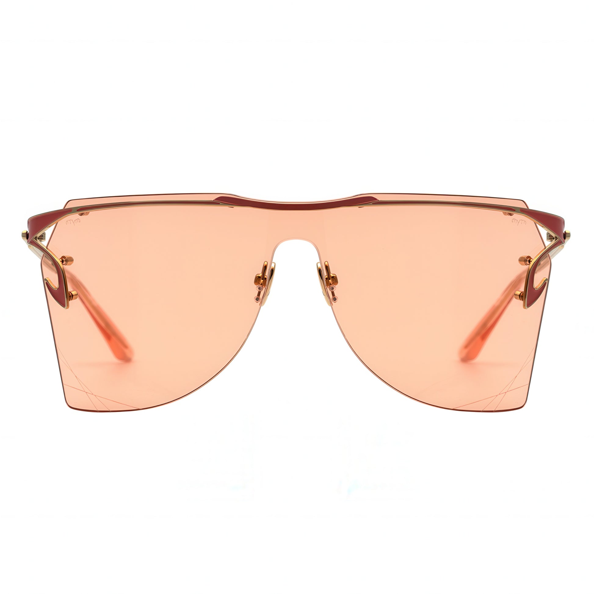 Sunglasses with peach-tinted lenses and gold frames on a white background