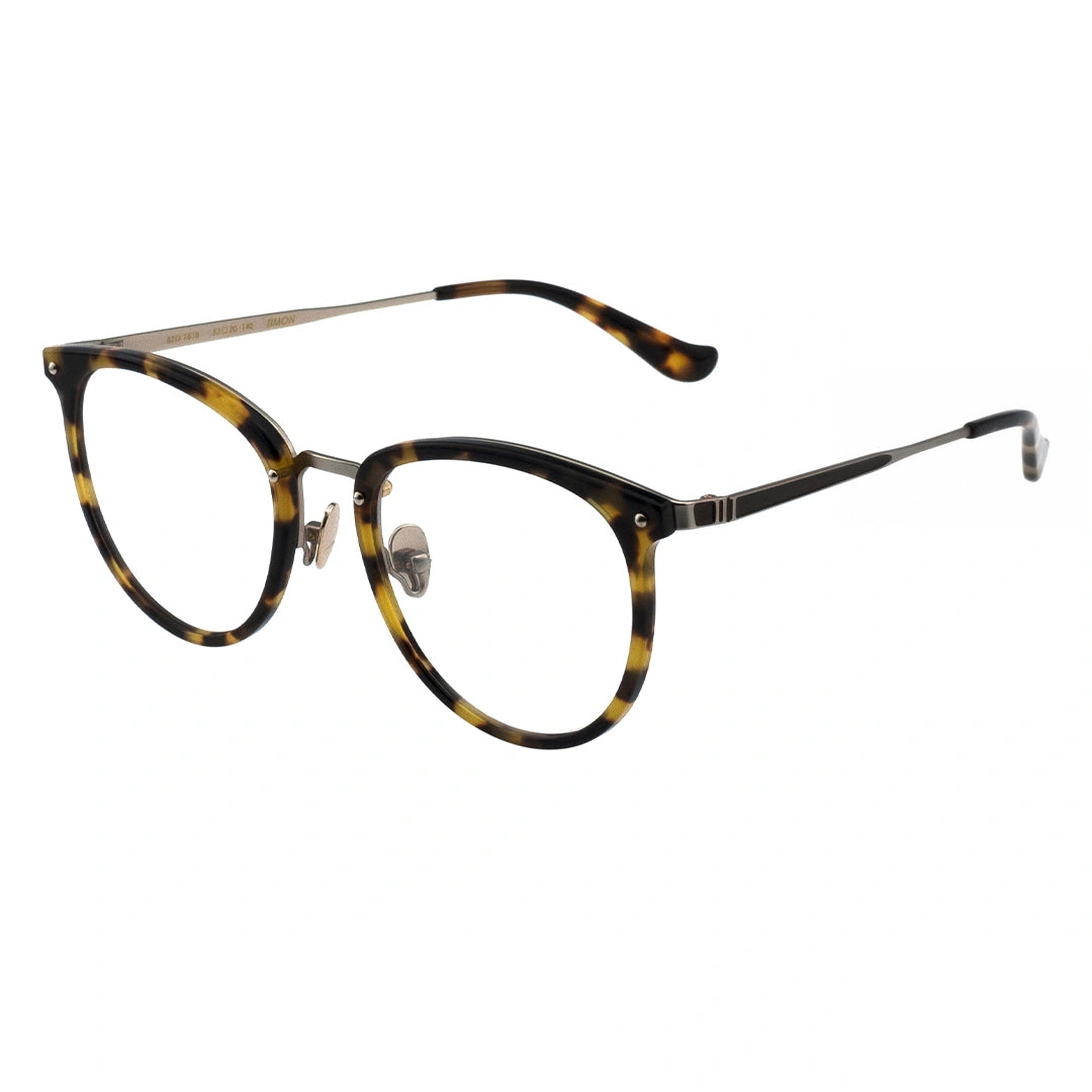 A pair of oval eyeglasses with a tortoise patterned frame and transparent lenses, featuring a metallic browline.