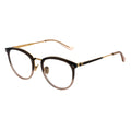 A pair of oval eyeglasses with a two-tone frame, gold and black temple