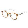 Pair of eyeglasses with a orange frame and silver accents 