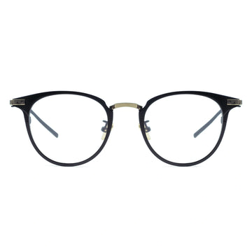 A pair of oval eyeglasses with a sleek frame design, featuring a blend of black and gold metal.