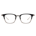 A pair of rectangular full frame eyeglasses with a browline design, featuring rose gold, black, and silver colors.