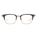 A pair of eyeglasses with a clubmaster style. The frame features dark brown/burgundy plastic on the top, with gold/light brown metal rimming the bottom of the lenses and connecting the bridge and nose pads. The temples are a contrasting matte gold/silver metal.