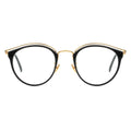 Front view of round black and gold combination eyeglasses with a layered gold metal browline.
