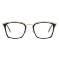 Front view of angular black and gold combination eyeglasses with a layered gold metal browline.