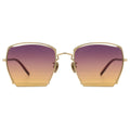 Front view of gold metal-framed OBLIVION sunglasses with oversized geometric lenses in gradient purple to orange, evoking a sunset fade.