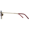 Eyeglasses with gold frame and red arms on a white background
